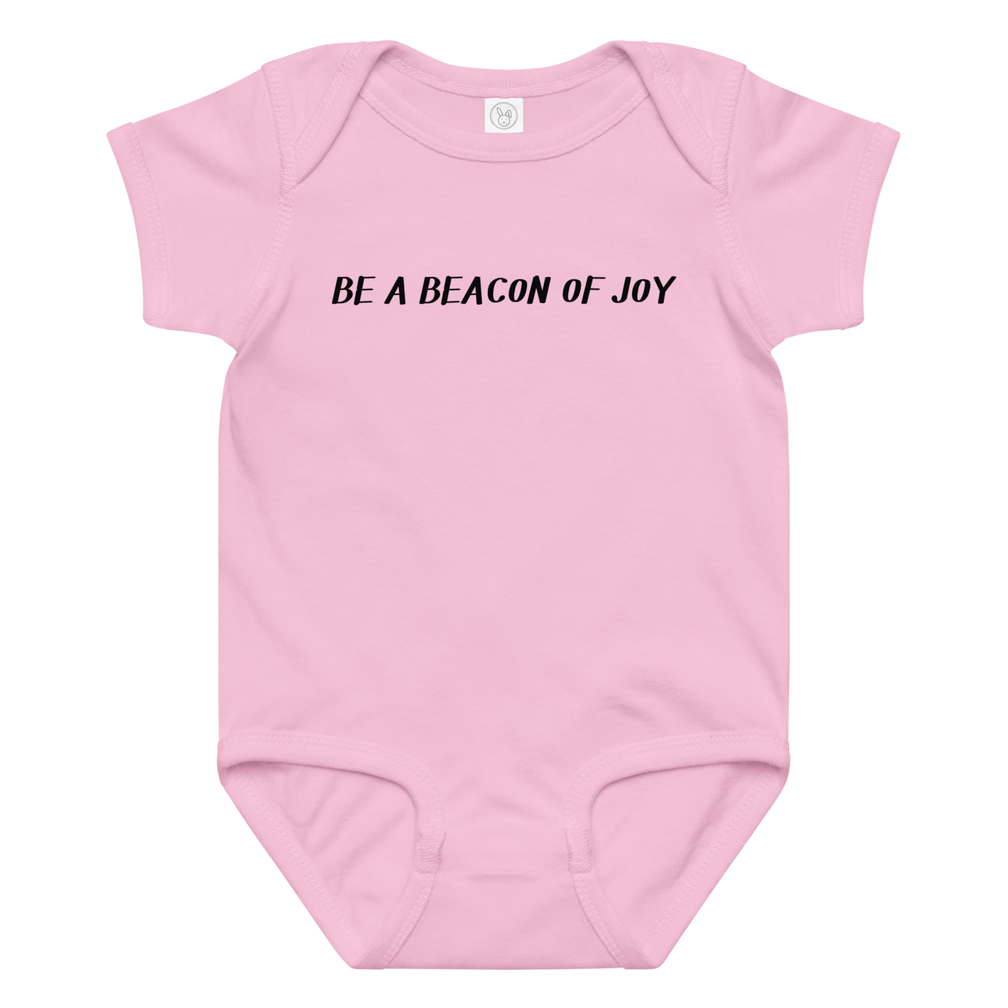 "Be a beacon of joy" printed on a pink baby jersey bodysuit laying on a flat surface amongst other clothes