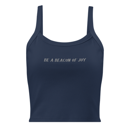 "Be a beacon of joy" printed on a solid navy blend women's micro-rib tanktop laying on a flat surface