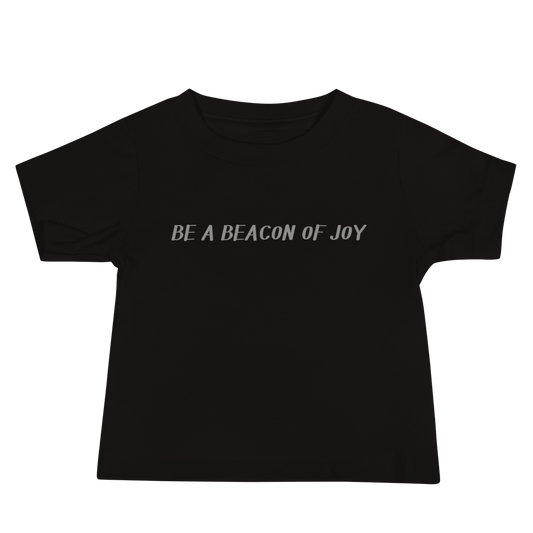 "Be a beacon of joy" printed on a black baby jersey short sleeve tee laying on a flat surface