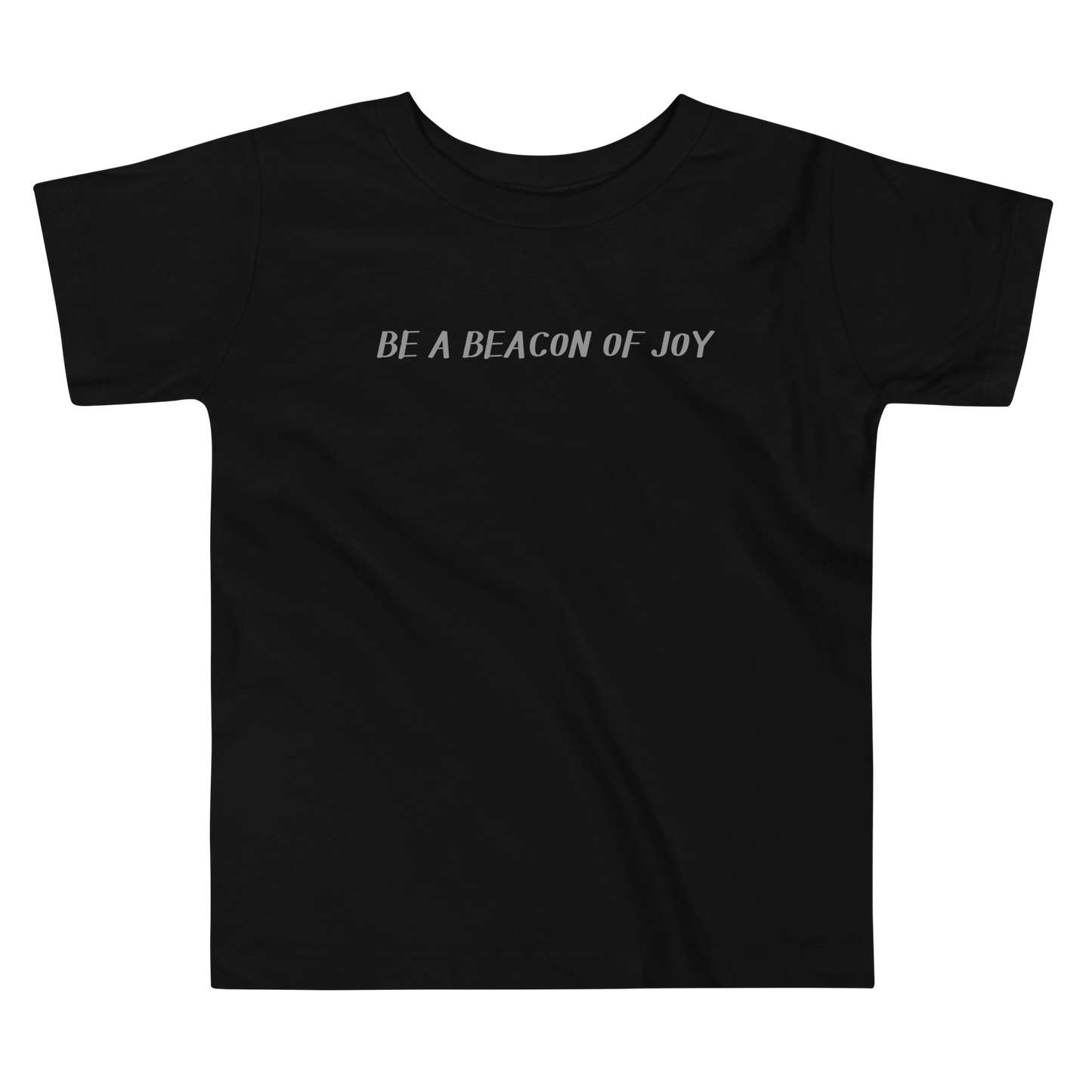 "Be a beacon of joy" printed on a black toddler short sleeve tee laying on a flat surface