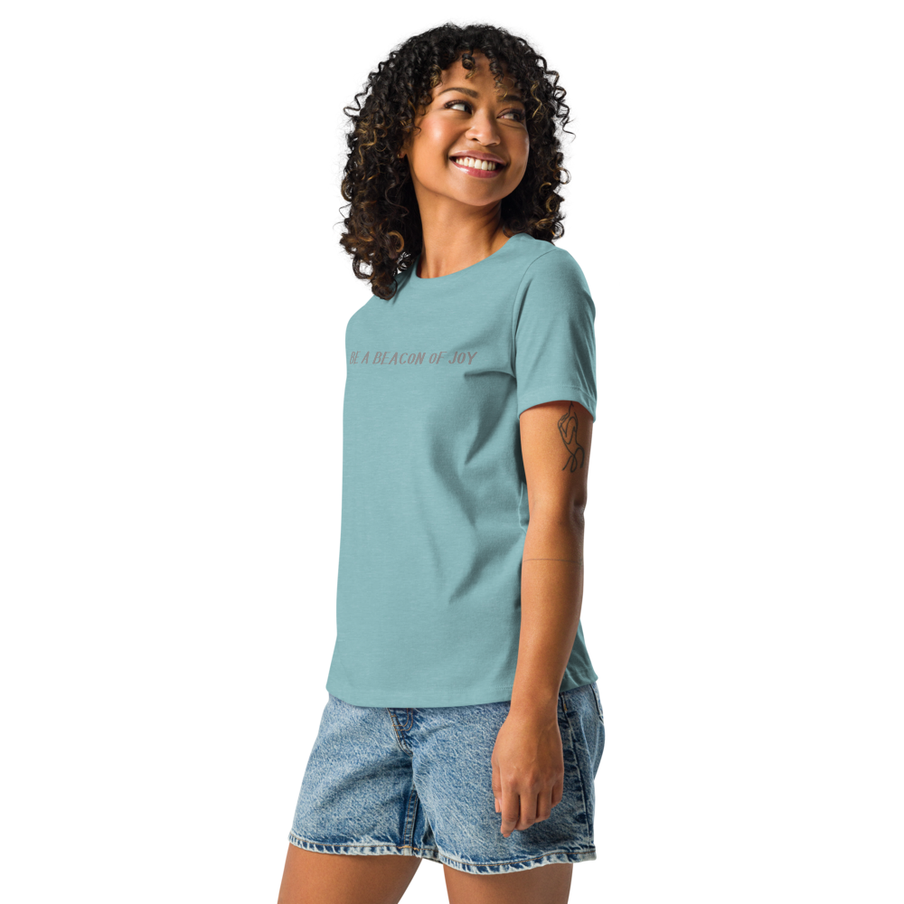 "Be a beacon of joy" printed on a heather blue lagoon women's relaxed t-shirt worn by a female
