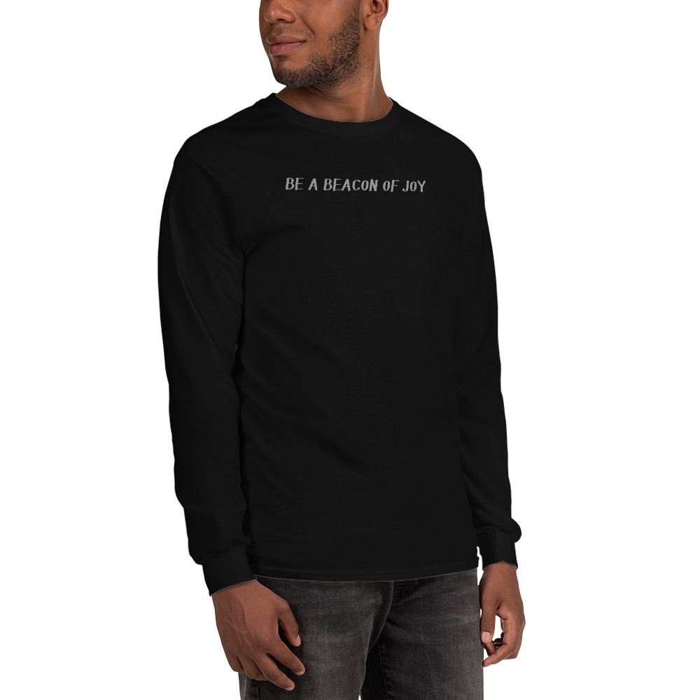 "Be a beacon of joy" printed on a black men's long sleeve shirt worn by a male