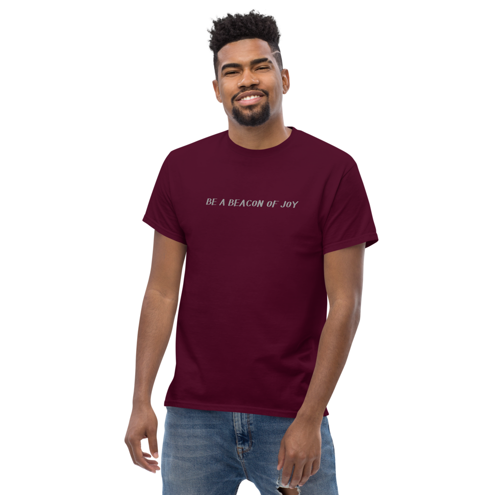 "Be a beacon of joy" printed on a maroon unisex classic tee worn by a male