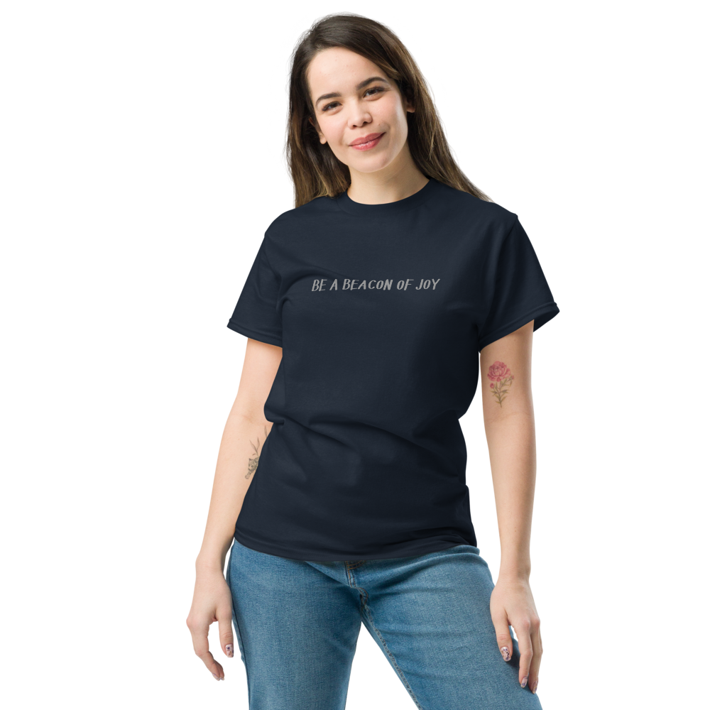 "Be a beacon of joy" printed on a navy unisex classic tee worn by a female