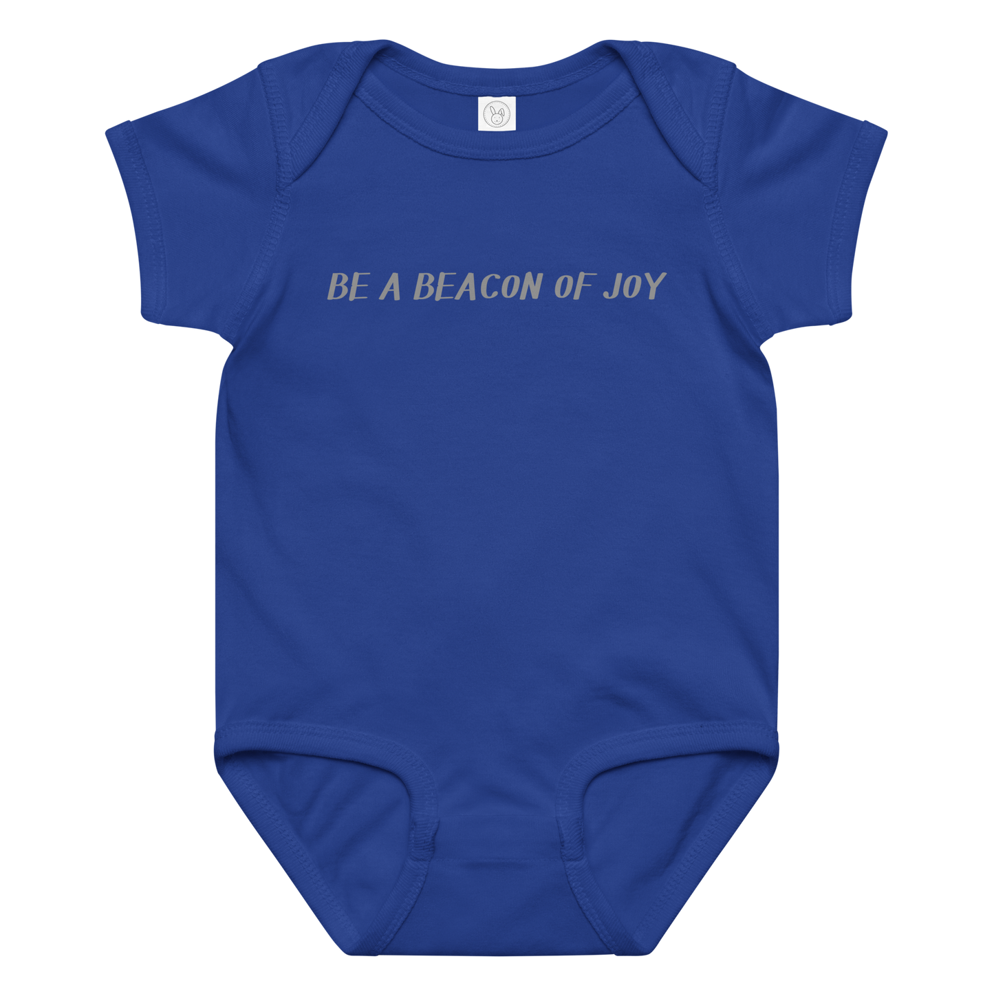 "Be a beacon of joy" printed on a royal baby jersey bodysuit laying on a flat surface amongst other clothes