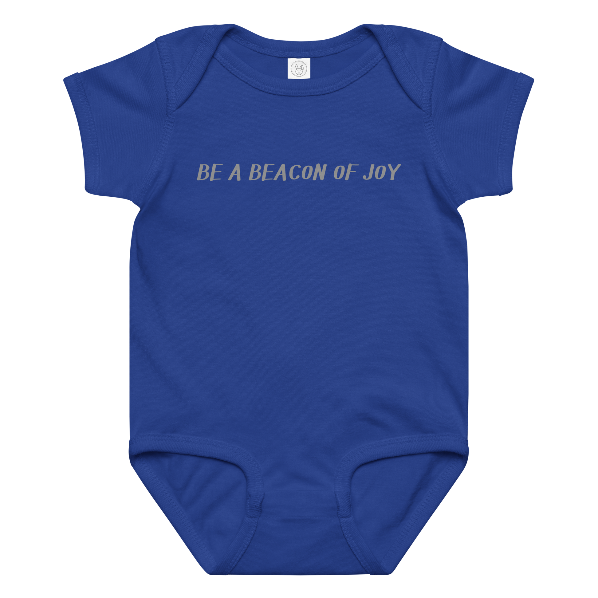"Be a beacon of joy" printed on a royal baby jersey bodysuit laying on a flat surface amongst other clothes