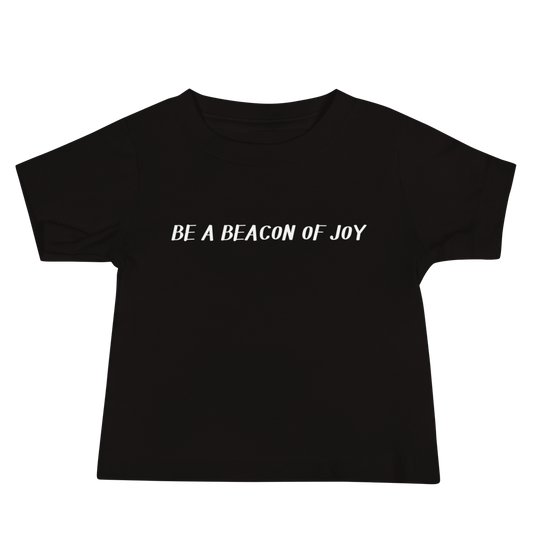 "Be a beacon of joy" printed on a black baby jersey short sleeve tee laying on a flat surface