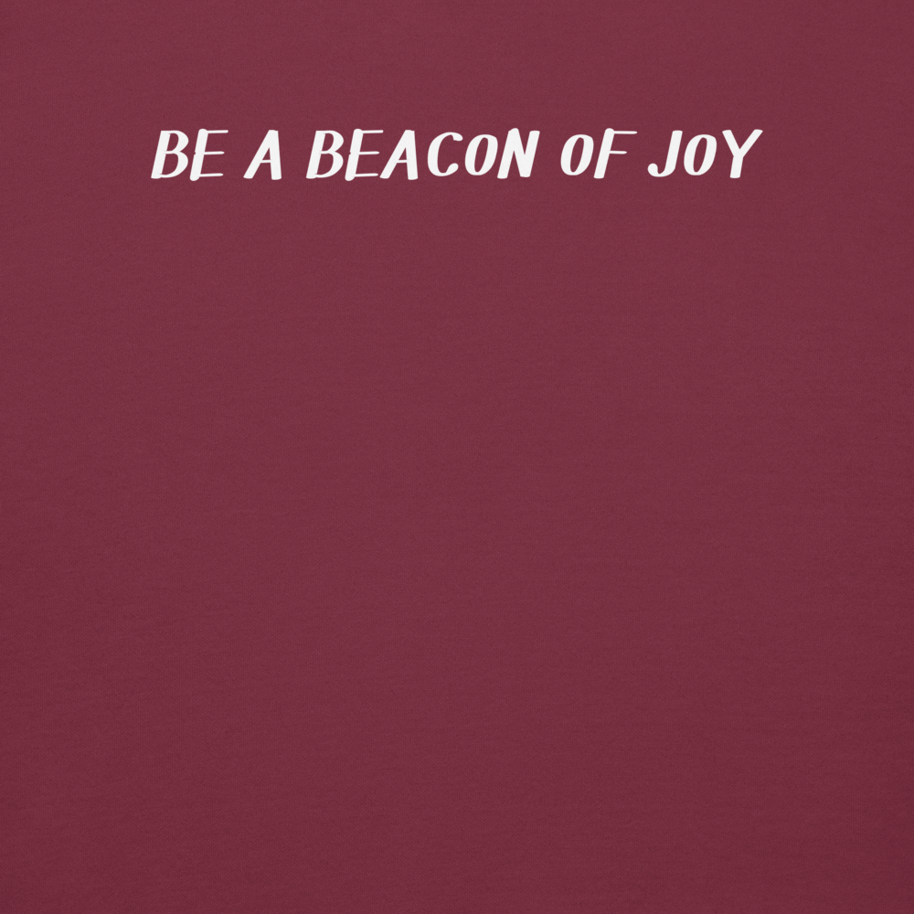 "Be a beacon of joy" printed on a maroon background