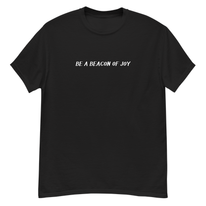 "Be a beacon of joy" printed on a black unisex classic tee laying on a flat surface