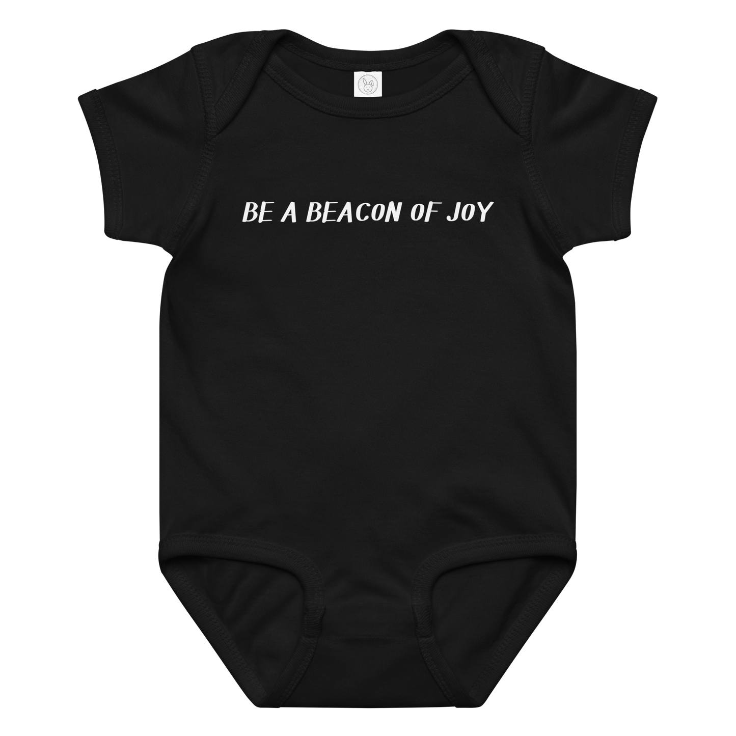 "Be a beacon of joy" printed on a black baby jersey bodysuit laying on a flat surface amongst other clothes