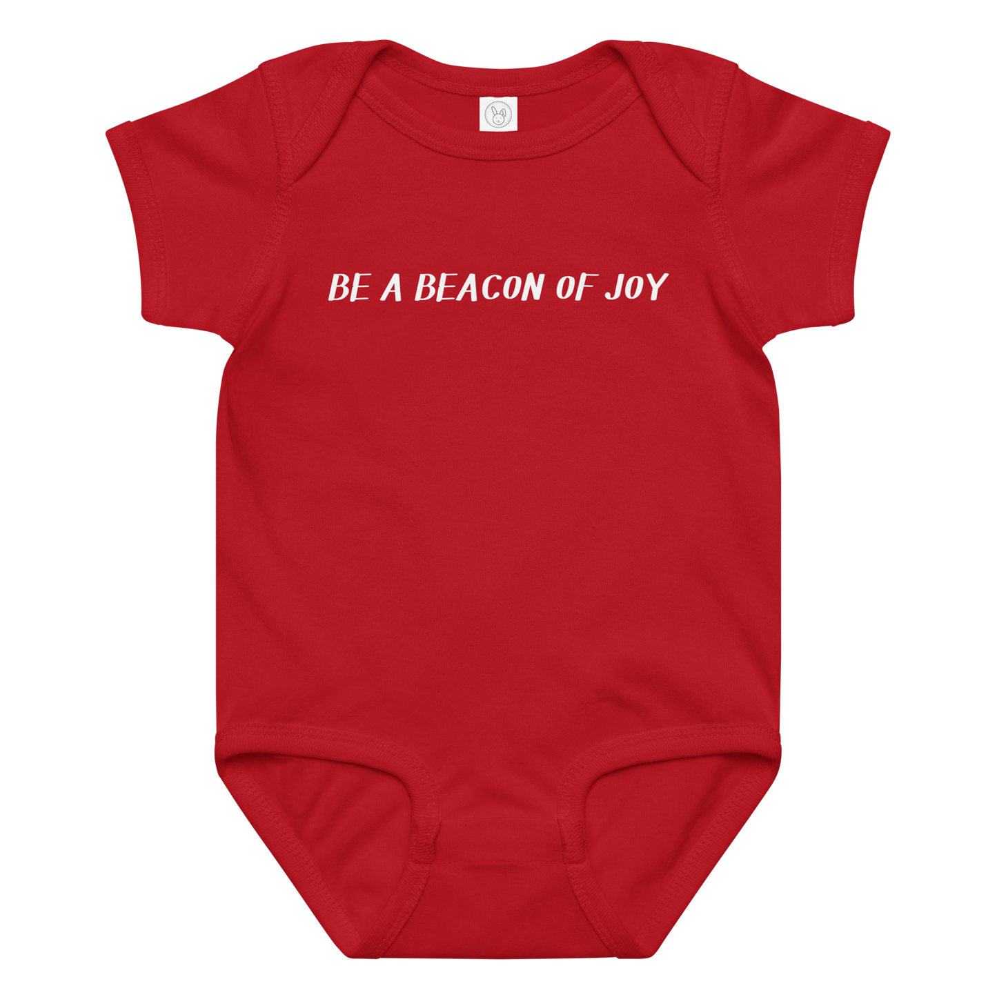 "Be a beacon of joy" printed on a red baby jersey bodysuit laying on a flat surface amongst other clothes