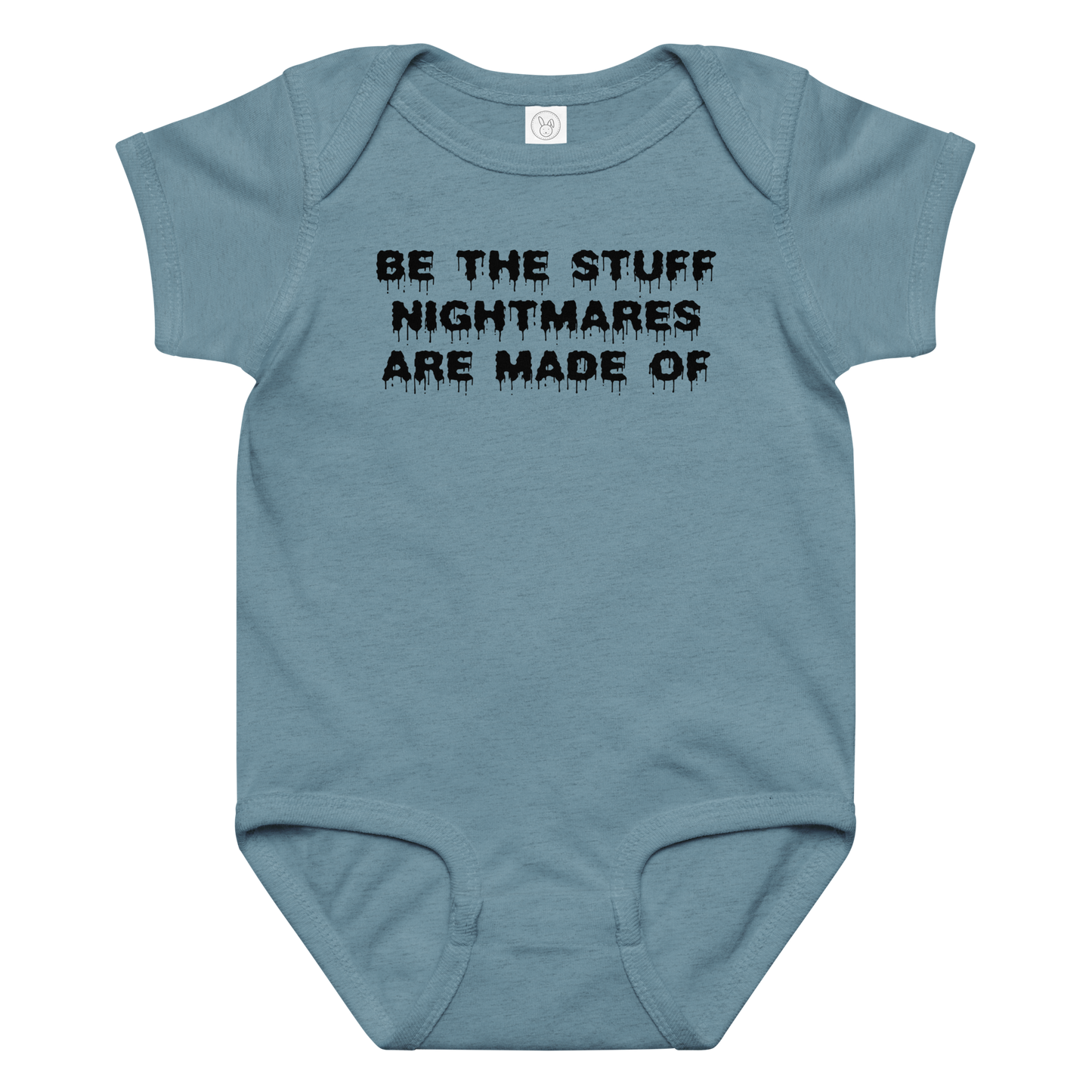 "Be the stuff nightmares are made of" printed on a vintage indigo baby jersey bodysuit laying on a flat surface amongst other clothes