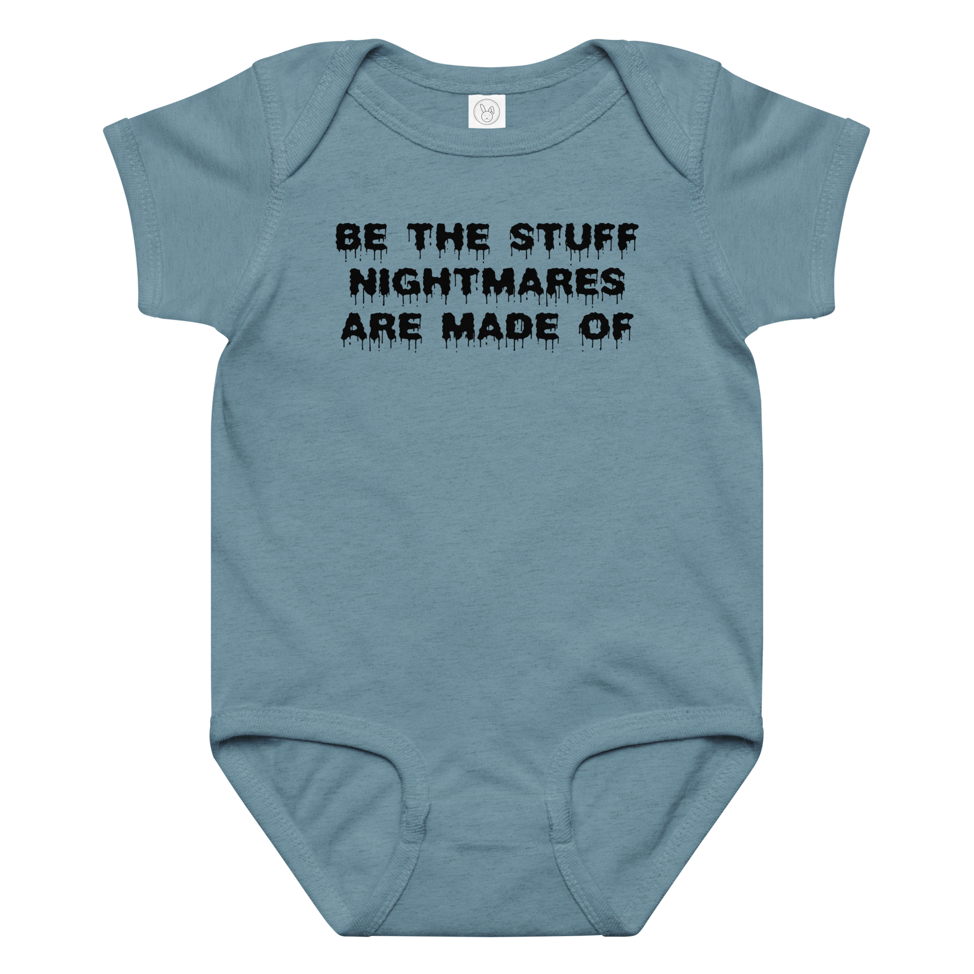 "Be the stuff nightmares are made of" printed on a vintage indigo baby jersey bodysuit laying on a flat surface amongst other clothes