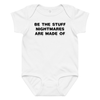"Be the stuff nightmares are made of" printed on a white baby jersey bodysuit laying on a flat surface amongst other clothes