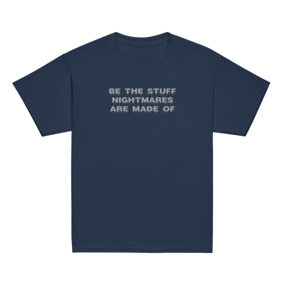 "Be the stuff nightmares are made of" printed on a navy youth classic tee laying on a flat surface