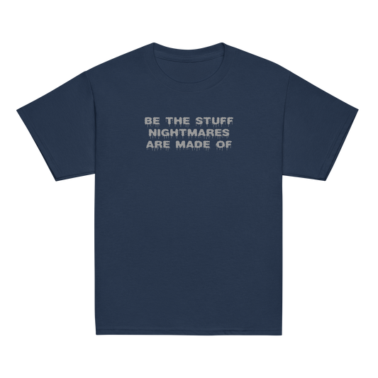 "Be the stuff nightmares are made of" printed on a navy youth classic tee laying on a flat surface
