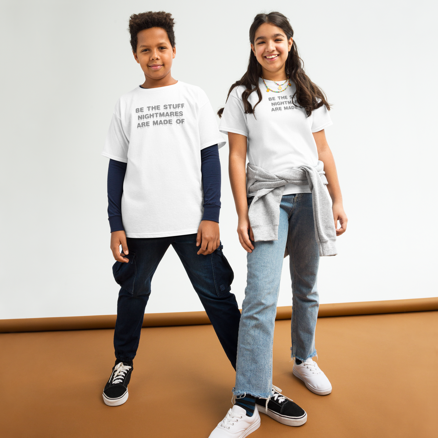 "Be the stuff nightmares are made of" printed on a white youth classic tee worn by a female and male