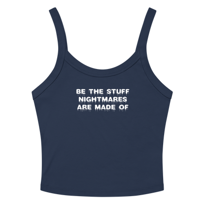 "Be the stuff nightmares are made of" printed on a solid navy blend women's micro-rib tanktop laying on a flat surface amongst sunglasses and shorts