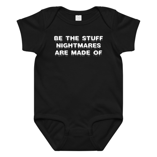 "Be the stuff nightmares are made of" printed on a black baby jersey bodysuit laying on a flat surface amongst other clothes