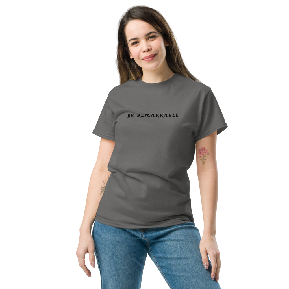 "Be remarkable" printed on a charcoal unisex classic tee worn by a female