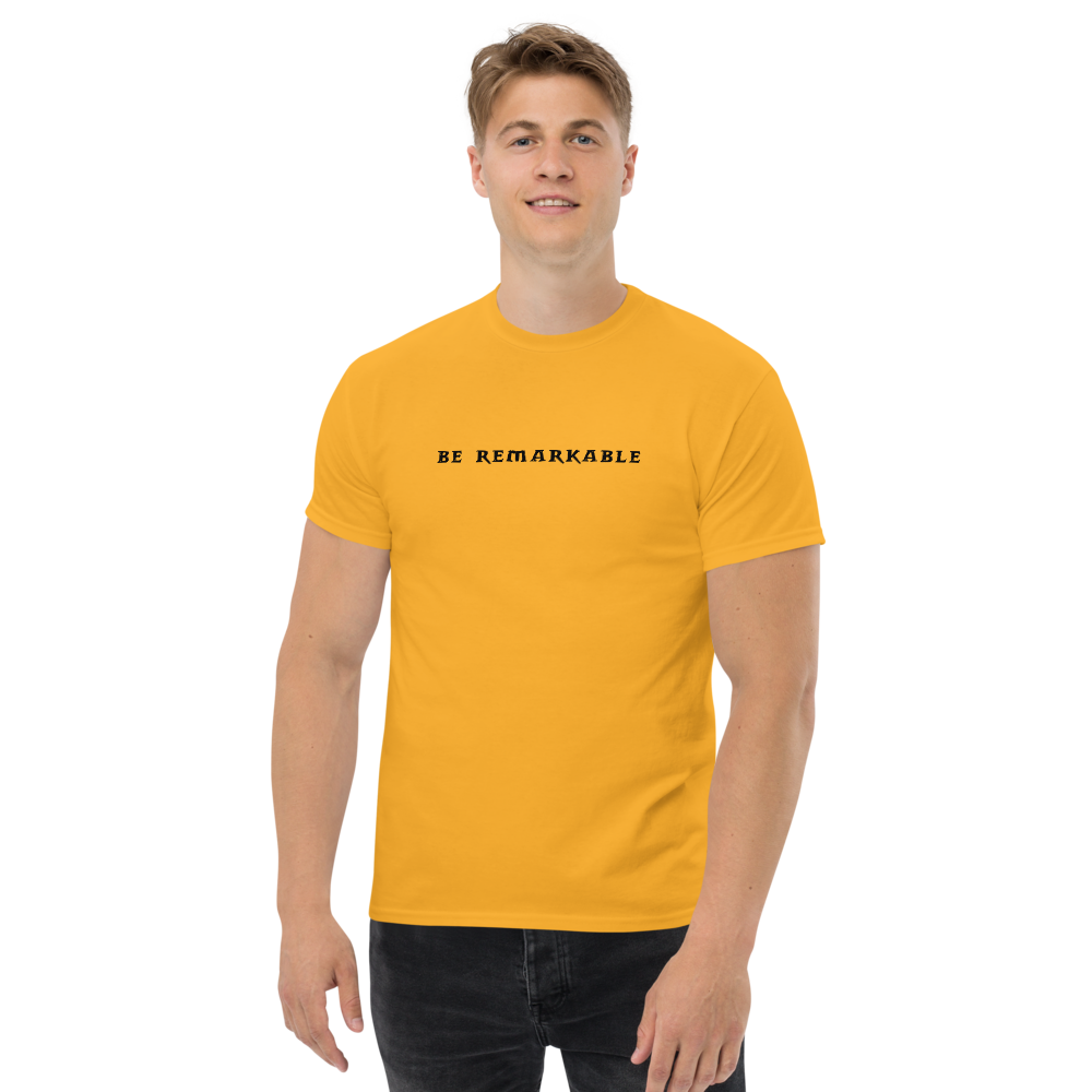 "Be remarkable" printed on a gold unisex classic tee worn by a male