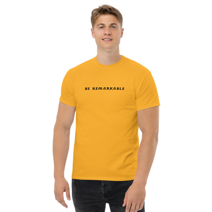 "Be remarkable" printed on a gold unisex classic tee worn by a male