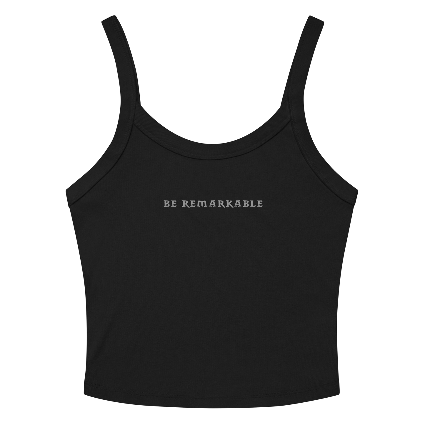 "Be remarkable" printed on a solid black blend women's micro-rib tanktop laying on a flat surface amongst sunglasses and shorts