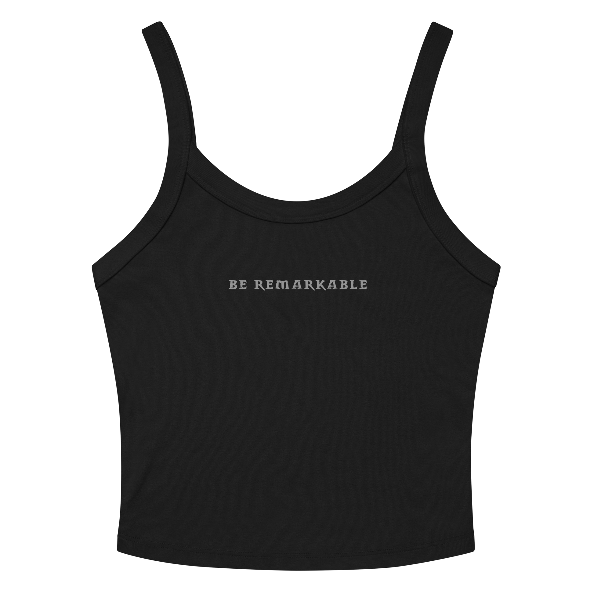 "Be remarkable" printed on a solid black blend women's micro-rib tanktop laying on a flat surface amongst sunglasses and shorts