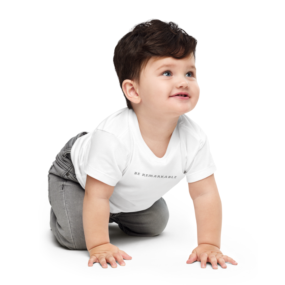"Be remarkable" printed on a white baby jersey short sleeve tee worn by a male who is crawling