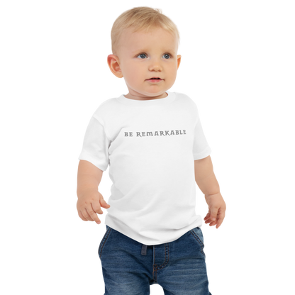 "Be remarkable" printed on a white baby jersey short sleeve tee worn by a male