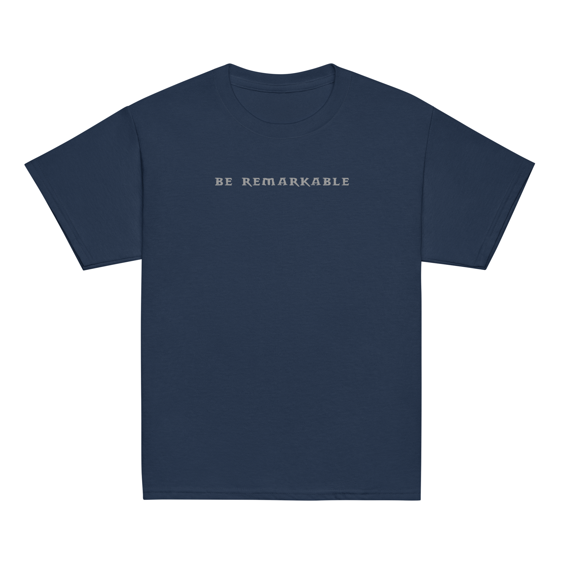 "Be remarkable" printed on a navy youth classic tee laying on a flat surface