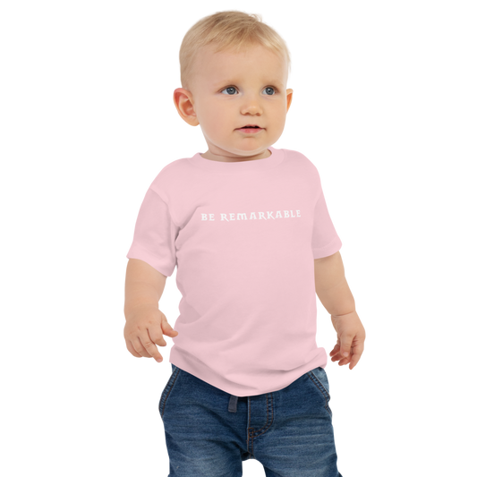 "Be remarkable" printed on a pink baby jersey short sleeve tee worn by a male