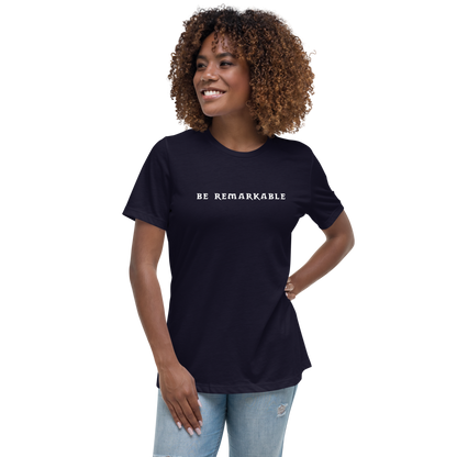 "Be remarkable" printed on a navy women's relaxed t-shirt worn by a female
