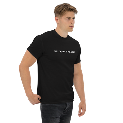 "Be remarkable" printed on a black unisex classic tee worn by a male
