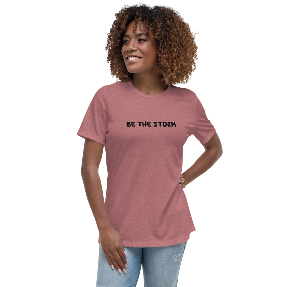 "Be the storm" printed on a heather mauve women's relaxed t-shirt worn by a female