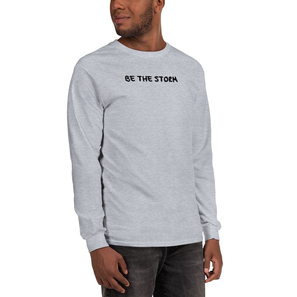 "Be the storm" printed on a sport grey men's long sleeve shirt worn by a male