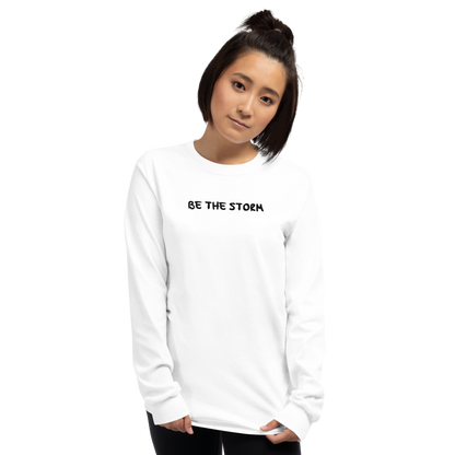 "Be the storm" printed on a white men's long sleeve shirt worn by a female