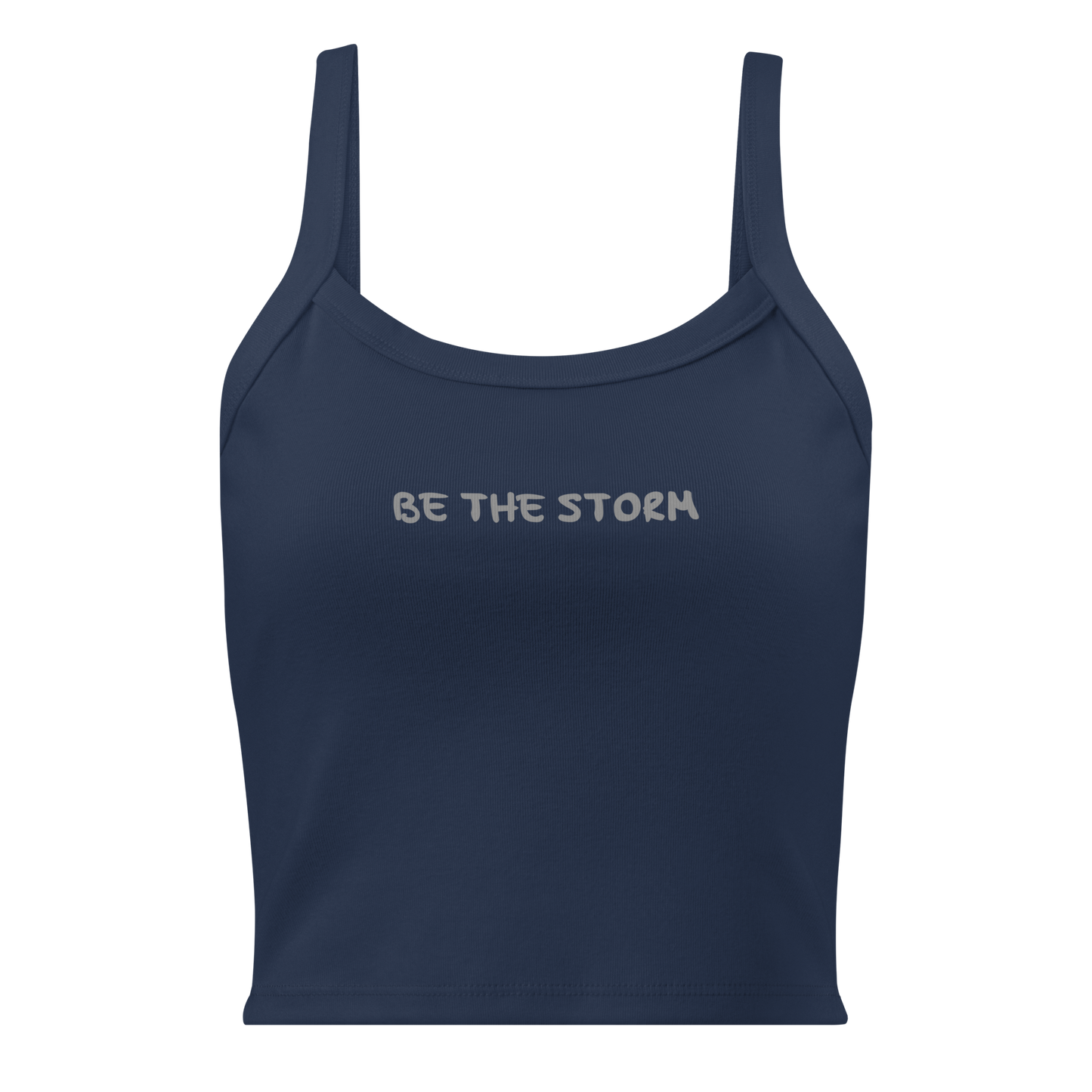 "Be the storm" printed on a solid navy blend women's micro-rib tanktop laying on a flat surface