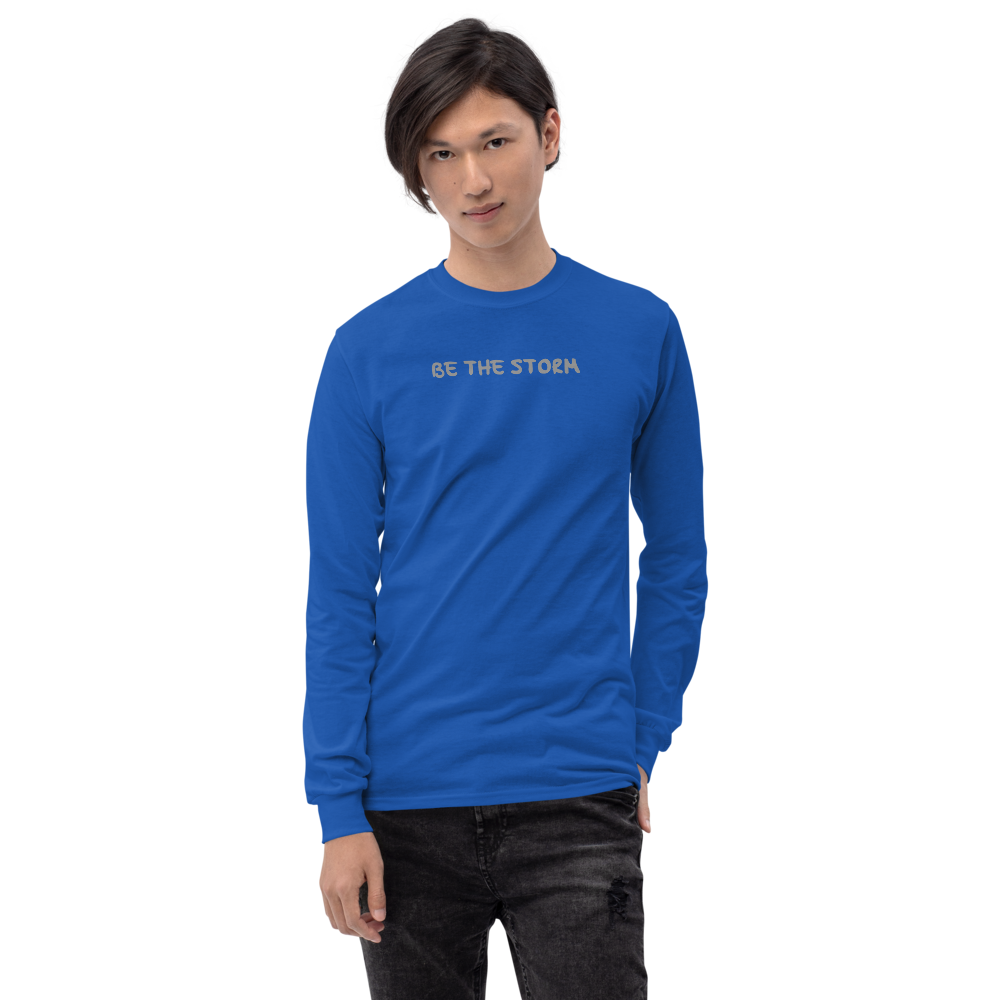 "Be the storm" printed on a royal men's long sleeve shirt worn by a male