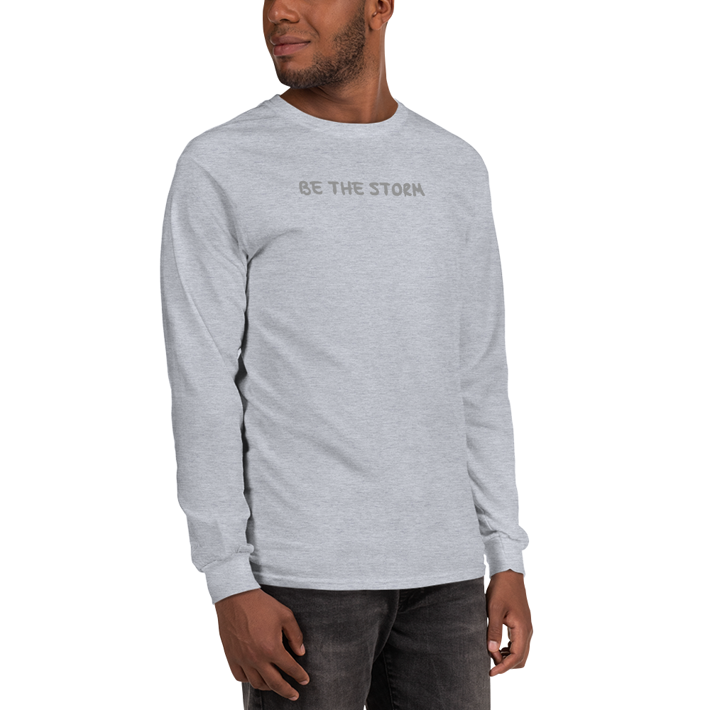 "Be the storm" printed on a sport grey men's long sleeve shirt worn by a male