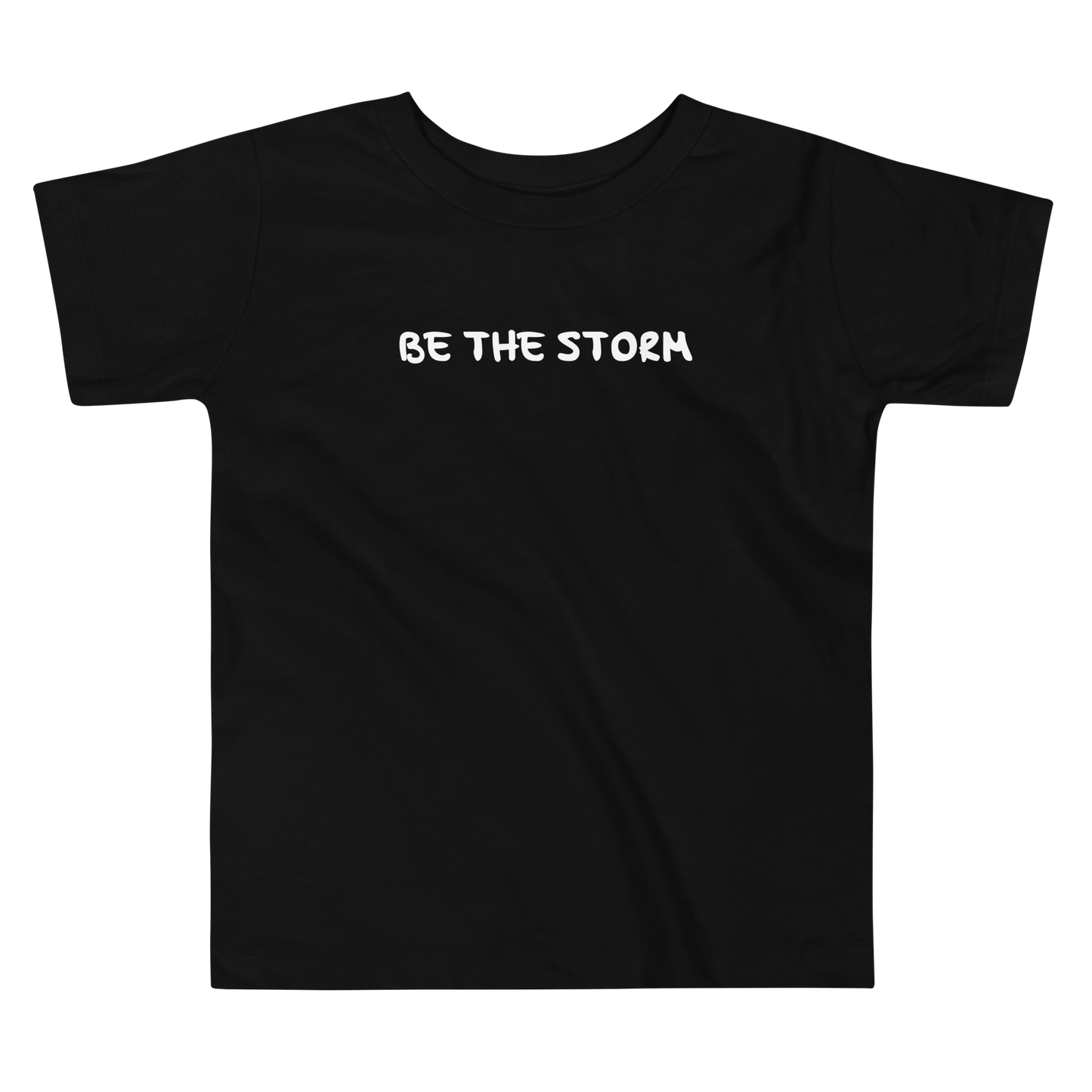 "Be the storm" printed on a black toddler short sleeve tee laying on a flat surface