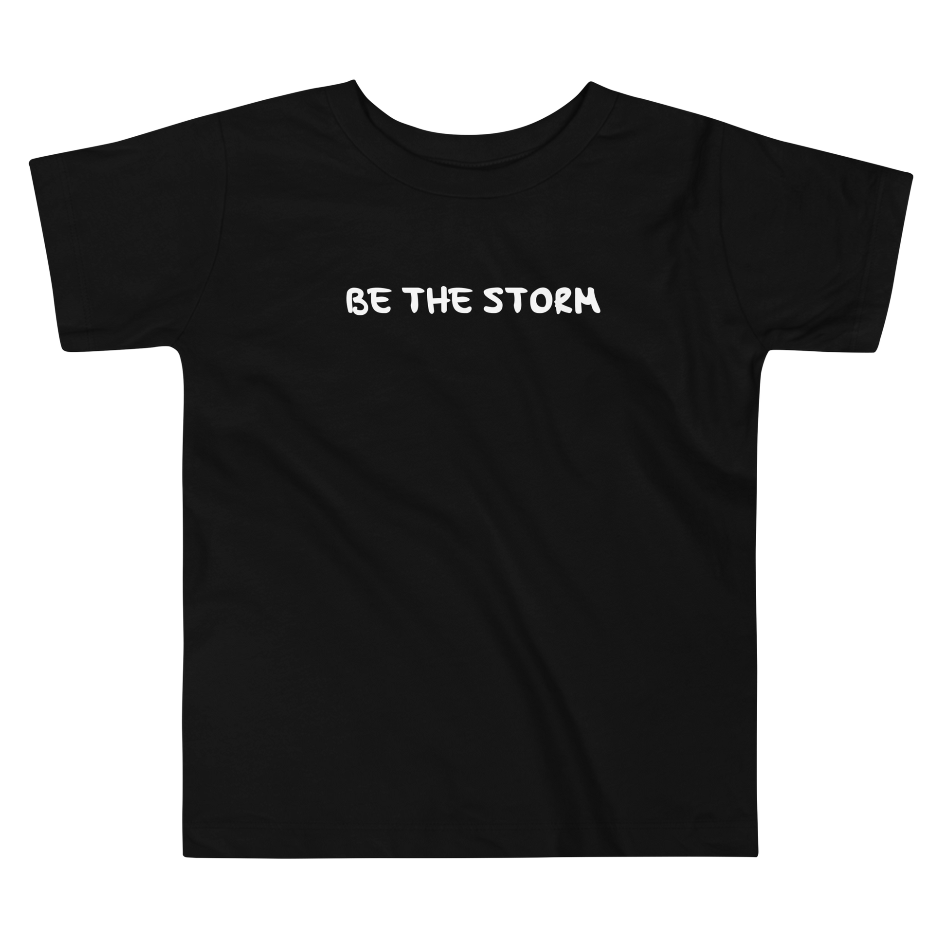 "Be the storm" printed on a black toddler short sleeve tee laying on a flat surface