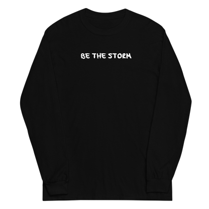 "Be the storm" printed on a black men's long sleeve shirt laying on a flat surface