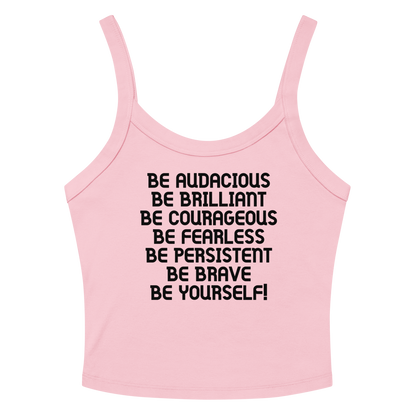 "Be Audacious Be Brilliant Be Courageous Be Fearless Be Persistent Be Brave Be Yourself!" printed on a solid pink blend women's micro-rib tanktop laying on a flat surface amongst sunglasses and shorts