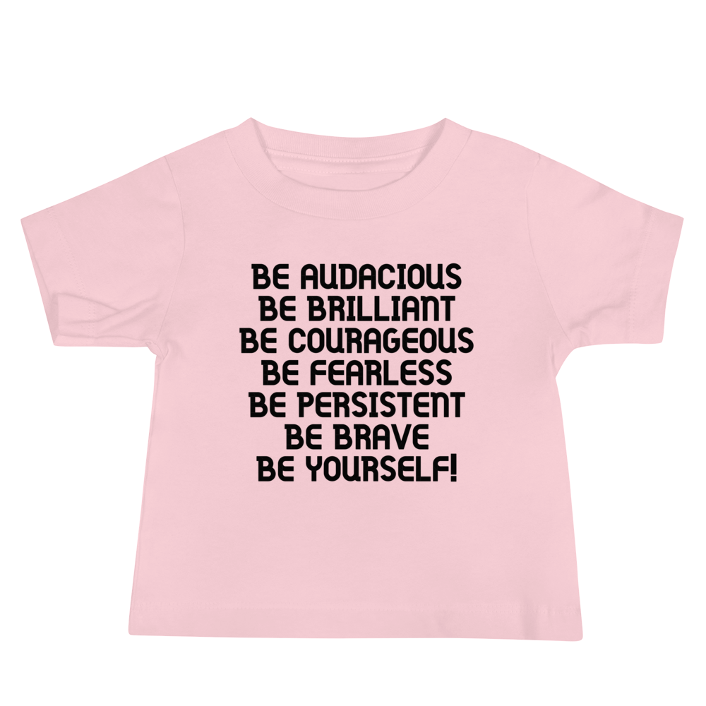 "Be Audacious Be Brilliant Be Courageous Be Fearless Be Persistent Be Brave Be Yourself!" printed on a pink baby jersey short sleeve tee laying on a flat surface