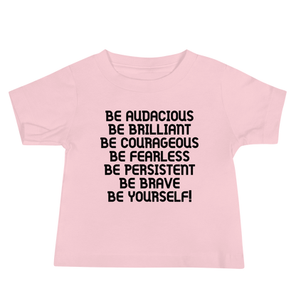 "Be Audacious Be Brilliant Be Courageous Be Fearless Be Persistent Be Brave Be Yourself!" printed on a pink baby jersey short sleeve tee laying on a flat surface