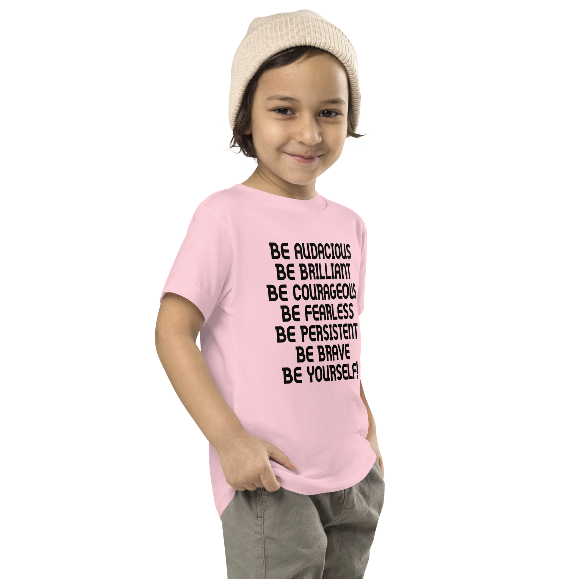"Be Audacious Be Brilliant Be Courageous Be Fearless Be Persistent Be Brave Be Yourself!" printed on a pink toddler short sleeve tee worn by a male who is also wearing a knit cap