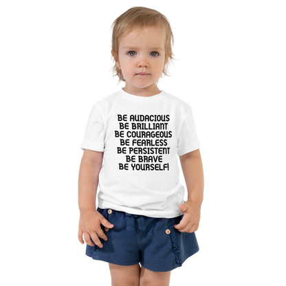 "Be Audacious Be Brilliant Be Courageous Be Fearless Be Persistent Be Brave Be Yourself!" printed on a white toddler short sleeve tee worn by a female