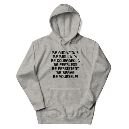 "Be Audacious Be Brilliant Be Courageous Be Fearless Be Persistent Be Brave Be Yourself!" printed on a carbon grey unisex hoodie laying on a flat surface with the hood up