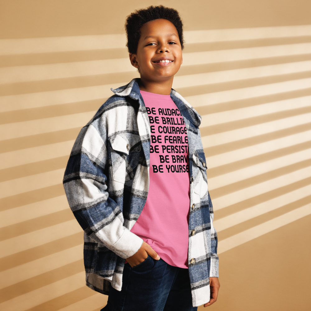 "Be Audacious Be Brilliant Be Courageous Be Fearless Be Persistent Be Brave Be Yourself!" printed on a azalea youth classic tee worn by a male also wearing a jacket